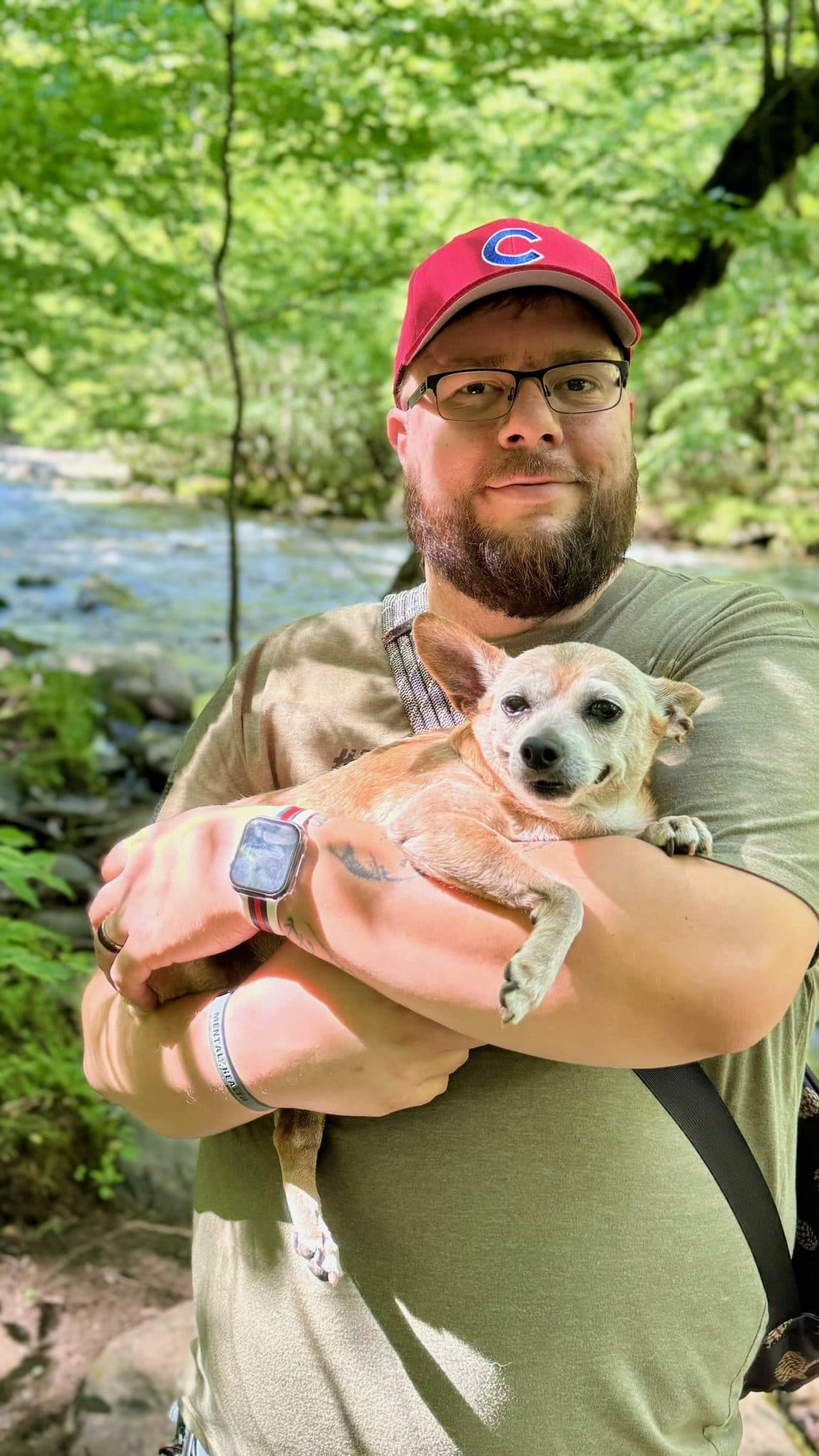 Brian holding Bobo beside a creek